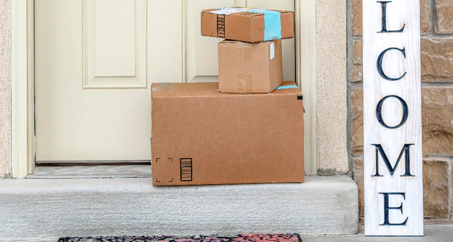 Boxes by the door of a residence with a welcome sign in Long Beach